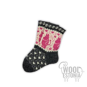 May include: A single gray, white, and pink wool sock. The cuff features a black and white pattern, with a pink and white design of rabbits and hearts. The toe of the sock has a black and white pattern. The sock is made of wool.