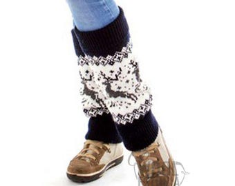 May include: Navy blue and white knit leg warmers with a reindeer and snowflake pattern. The leg warmers are worn with blue jeans and brown shoes. The leg warmers have a ribbed navy blue cuff at the top and bottom.