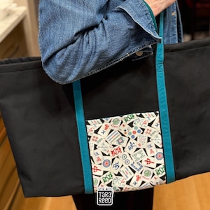 Large American Mahjong tote bag sewing pattern with front pocket and shoulder straps for carrying racks, tiles, and game accessories.