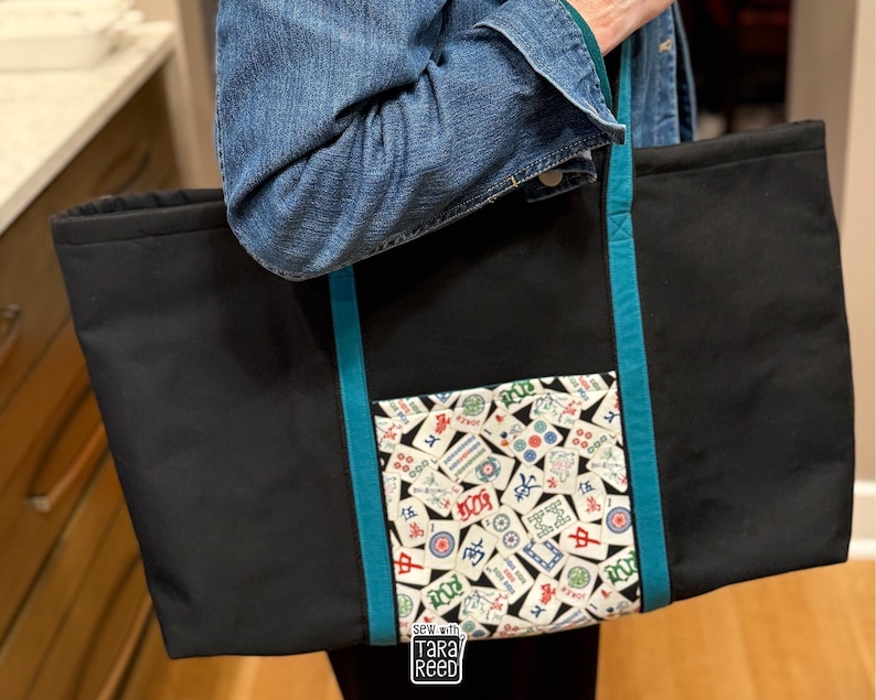 Large American Mahjong tote bag sewing pattern with front pocket and shoulder straps for carrying racks, tiles, and game accessories.