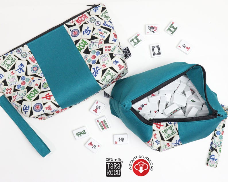 Two finished Mahjong tile bags made from sewing tutorial, showing wristlet strap, zipper closure, and structured bag shape