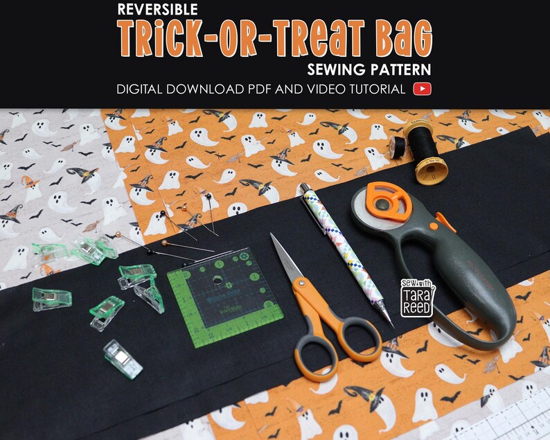 Materials needed for reversible trick or treat bag sewing pattern including Halloween fabric, rotary cutter, scissors, ruler, clips, and thread.