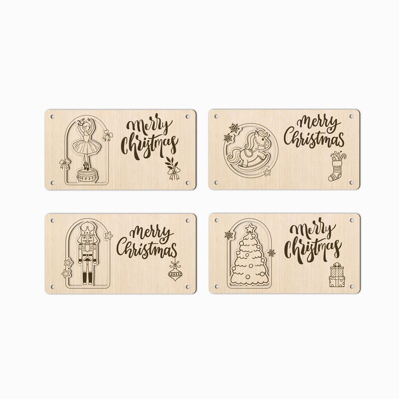 May include: Four rectangular wooden Christmas ornaments with engraved designs. Each features a different holiday image: a ballerina, a rocking horse, a nutcracker, and a Christmas tree. The words "Merry Christmas" are also engraved.