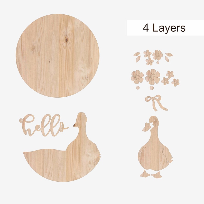 May include: Wooden wall decor set featuring a large round piece, a duck silhouette, the word "hello", and floral and bow accents. The pieces are made of light-colored wood and are designed to be layered.