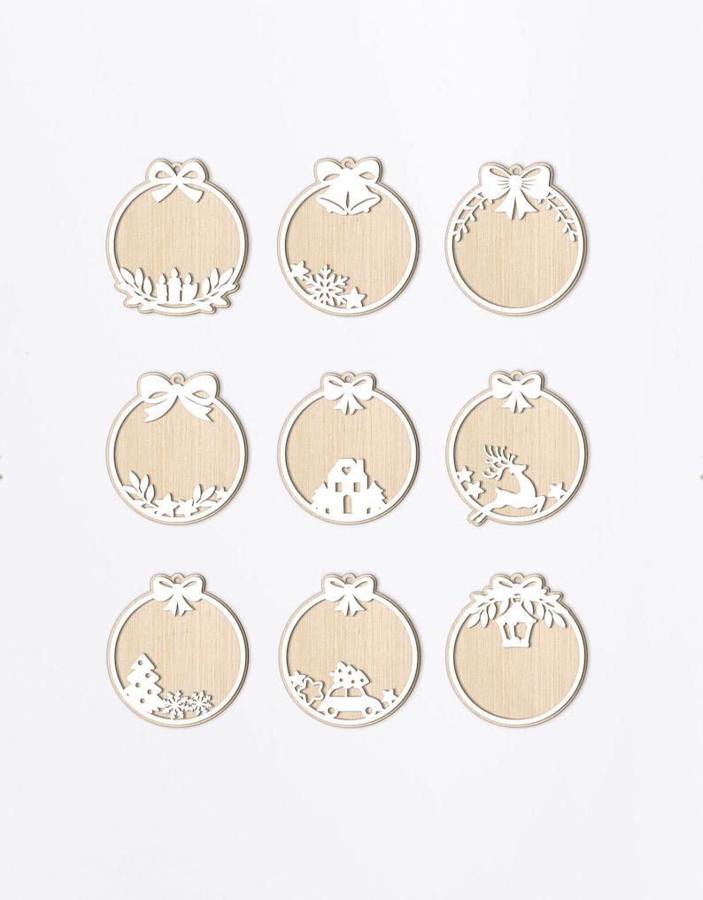 May include: Nine white wooden Christmas ornament cutouts with different designs. The ornaments are round and have a hole at the top for hanging. The designs include a bow, bells, a house, a reindeer, a Christmas tree, a car, and a lantern.