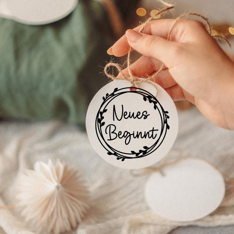 May include: A white ceramic mug with a black handle and the text "But First, Coffee" in a black, bold font. The mug is on a white surface. The mug is approximately 4 inches tall.