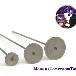 May include: Three silver metal tools with round, flat ends and long, thin handles. The tools are arranged in order of size, with the largest tool on the right and the smallest tool on the left. The tools are labelled "MADE BY LAMPWORKTOOL".