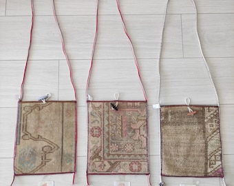 May include: Three small, rectangular, fabric bags with different patterns and colors. Each bag has a long strap and is numbered 1, 2, and 3.