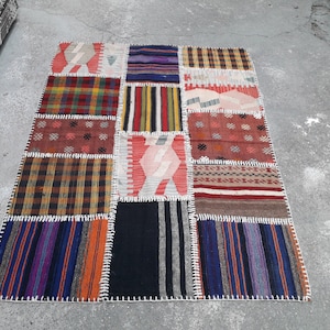 May include: A patchwork rug made of different colored and patterned fabric squares. The rug is made of wool and has a fringed edge.