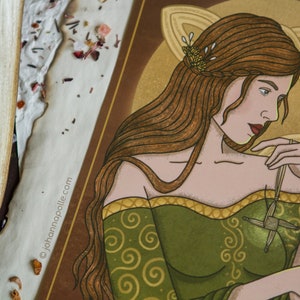 May include: A digital illustration of a woman with long brown hair wearing a green dress with gold trim. She is holding a woven cross in her hand. The background is a gold Celtic knot design.