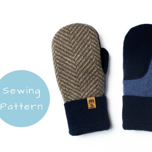 Może przedstawiać: Dwie pary rękawic, jedna para jest brązowa i beżowa z wzorem w jodełkę i granatowym mankietem, druga para jest granatowa z niebieskim dżinsowym łatką na kciuku i granatowym mankietem. Rękawice mają małą brązową etykietę z tekstem "Tree & Pine" na nich.