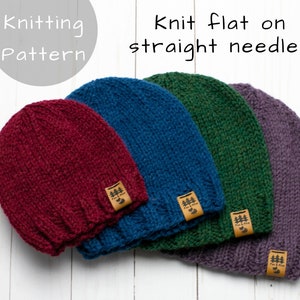 May include: Four knitted hats in different colours: burgundy, blue, green, and purple. Each hat has a small brown leather tag with a tree logo and the text "Fox & Pine". The text "Knitting Pattern" and "Knit flat on straight needles" is written above the hats.