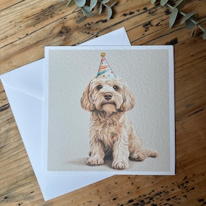 May include: A birthday card featuring a cute, light brown dog wearing a colourful party hat. The dog is sitting and looking directly at the viewer.