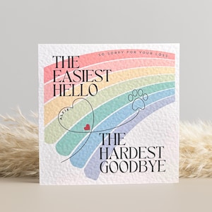 May include: A sympathy card with a rainbow and paw print design. The text reads "The easiest hello, the hardest goodbye." and "So sorry for your loss."