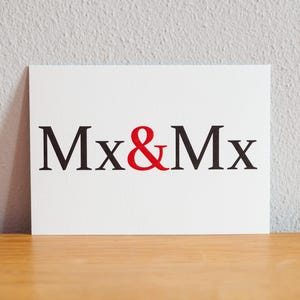 May include: White card with the text "Mx&Mx" in black letters with an ampersand in red.