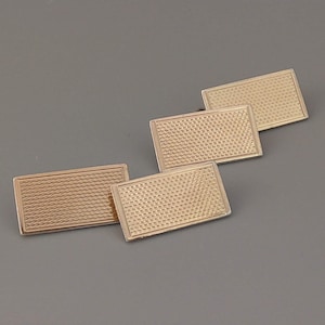 May include: Four gold-toned cufflinks with a textured, woven pattern.