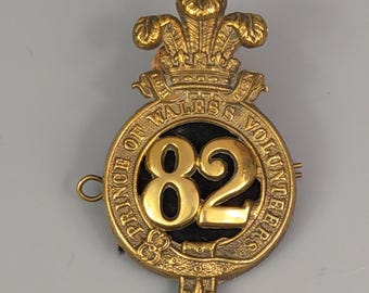 Insignia de gorra del Regimiento de Voluntarios del Príncipe de Gales del 82.º Regimiento de Infantería