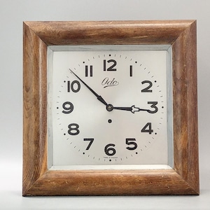 Art deco Large wall clock by Odo in a square wood frame with a silver face and black hands
