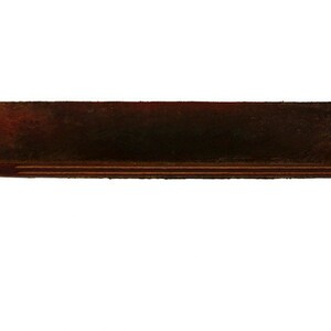 May include: A wooden and leather strop for sharpening straight razors. The strop has a wooden handle and a leather strap.