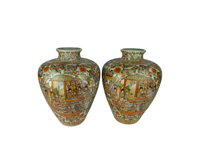 May include: Two large, ornate porcelain vases with a white background and colorful floral and figural designs. The vases are decorated with a scene of people in a palace setting.