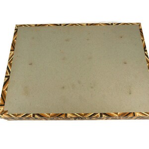 May include: A rectangular box with a brown, black and white geometric pattern on the lid. The box is made of wood and has a hinged lid.