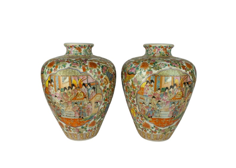 May include: Two large, white porcelain vases with intricate floral and figural designs in shades of green, orange, pink, and blue. The vases feature a scene of people in traditional Chinese clothing.