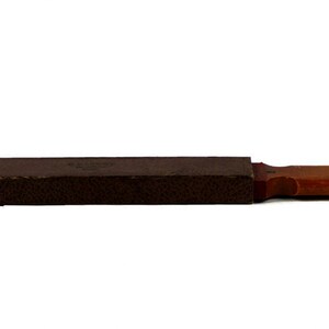 May include: A brown leather case with a wooden handle. The case is closed and appears to be for a small tool or instrument.