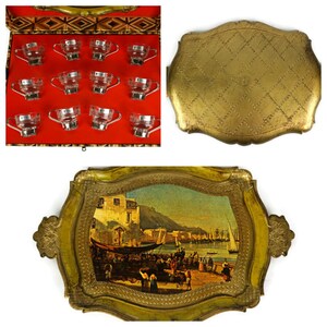 May include: A set of 12 clear glass cups with gold rims, displayed in a wooden box with a red velvet lining. The box is open and the cups are arranged in rows.