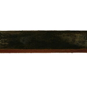 May include: A dark green leather strop with a wooden base. The strop is used to sharpen straight razors.