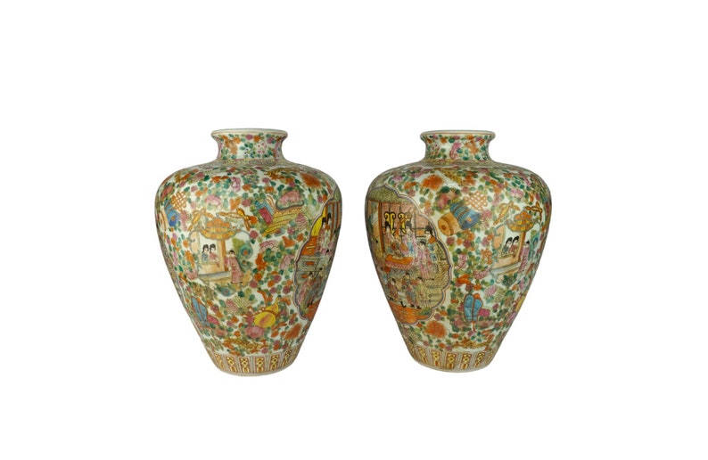 May include: Two white porcelain vases with a floral and figural design. The vases are decorated with a colorful pattern of flowers, birds, and people. The vases are approximately 12 inches tall.