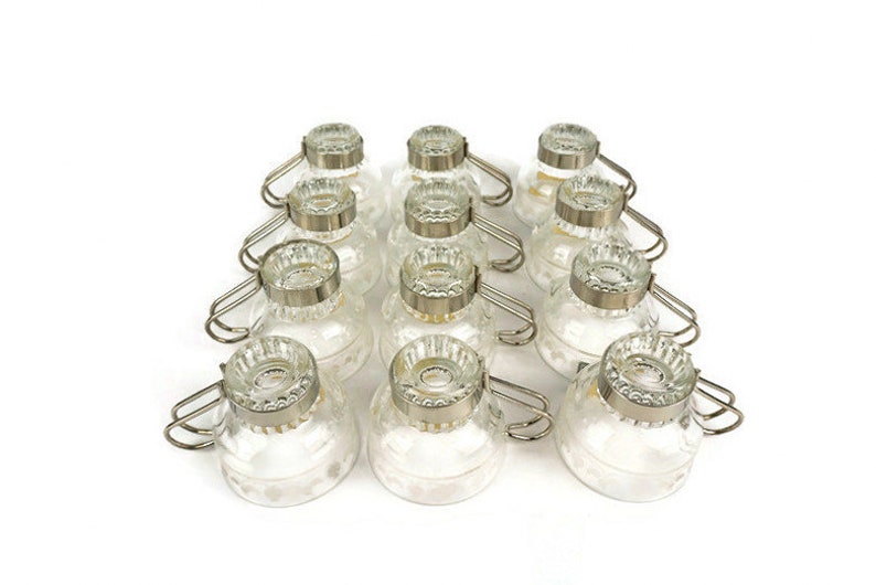 May include: Set of 12 clear glass cups with silver metal handles. The cups have a decorative pattern and are ideal for serving coffee, tea, or other beverages.