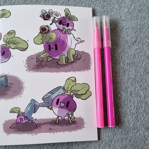 May include: A small notebook with a white background and illustrations of purple and white turnip characters. The characters are wearing faces and are interacting with each other. There are two pink pens next to the notebook.