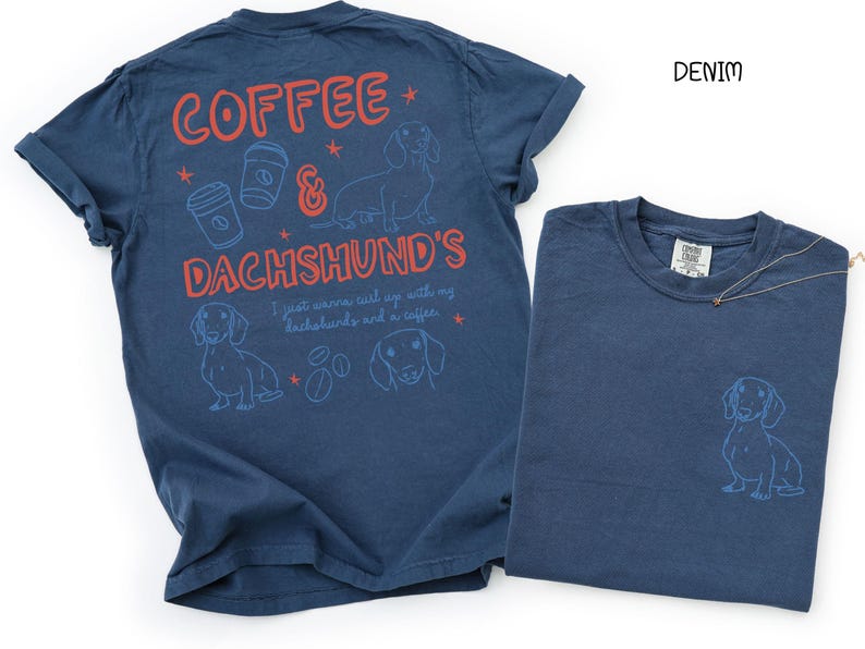 May include: Two denim blue t-shirts. One shirt has the text "COFFEE & DACHSHUND'S" with illustrations of coffee cups, stars, and dachshunds. The other shirt has a dachshund illustration. The word "DENIM" is printed in black.