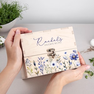 May include: A wooden recipe box with a floral design and the text "Rachel's Favorite Recipes" on the front.