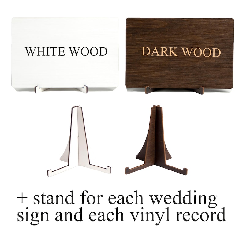 May include: Two wooden signs, one white and one dark brown, with the text "WHITE WOOD" and "DARK WOOD" respectively. Each sign is on a small wooden easel.