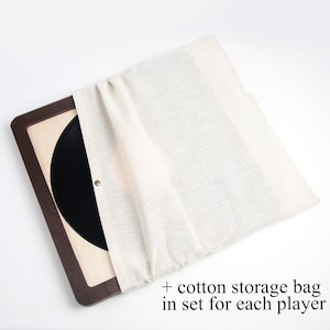 May include: A wooden record storage box with a black vinyl record inside. A white cotton storage bag is included in the set.