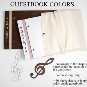 May include: Two wooden guestbooks, one dark wood and one white wood, with a cotton storage bag, a treble clef bookmark, and 30 blank ivory sheets inside.  GUESTBOOK COLORS.