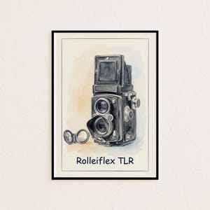 May include: Watercolor print of a Rolleiflex TLR camera in black and gray, with a lens cap. The camera is set against a beige and white background, framed in black. The text "Rolleiflex TLR" is below the camera.