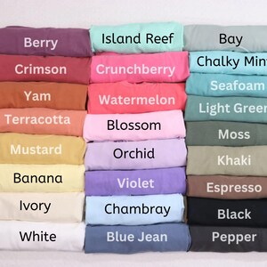 May include: A colour chart of 24 fabric swatches, each with a different colour and name. The colours include Berry, Crimson, Yam, Terracotta, Mustard, Banana, Ivory, White, Island Reef, Crunchberry, Watermelon, Blossom, Orchid, Violet, Chambray, Blue Jean, Bay, Chalky Mint, Seafoam, Light Green, Moss, Khaki, Espresso, Black, and Pepper.