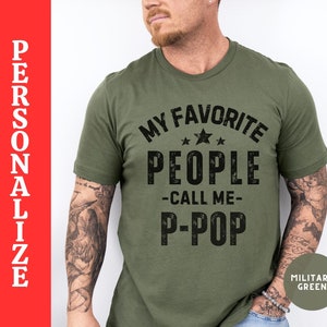 May include: A green t-shirt with a distressed black graphic that reads "My Favorite People -Call Me- P-Pop" with three stars above the word "People".