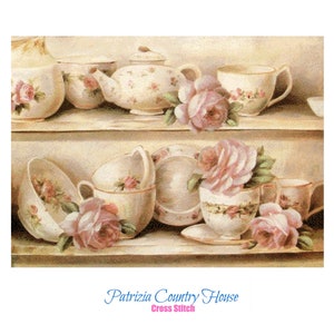 Può includere: Un motivo di ricamo a punto croce in stile vintage che presenta una collezione di tazze da tè, piattini e una teiera decorate con motivi floreali. Rose rosa sono disposte in tutta l'immagine, aggiungendo un tocco di fascino romantico.