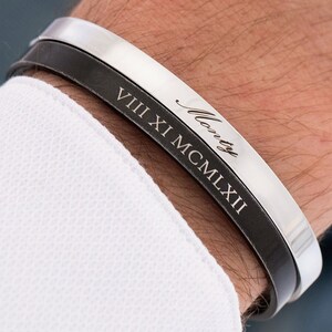 May include: A black leather and silver cuff bracelet with the inscription "Monty VIII XI MCMXLII".