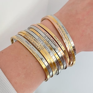 Different fonts on a stack of bracelets