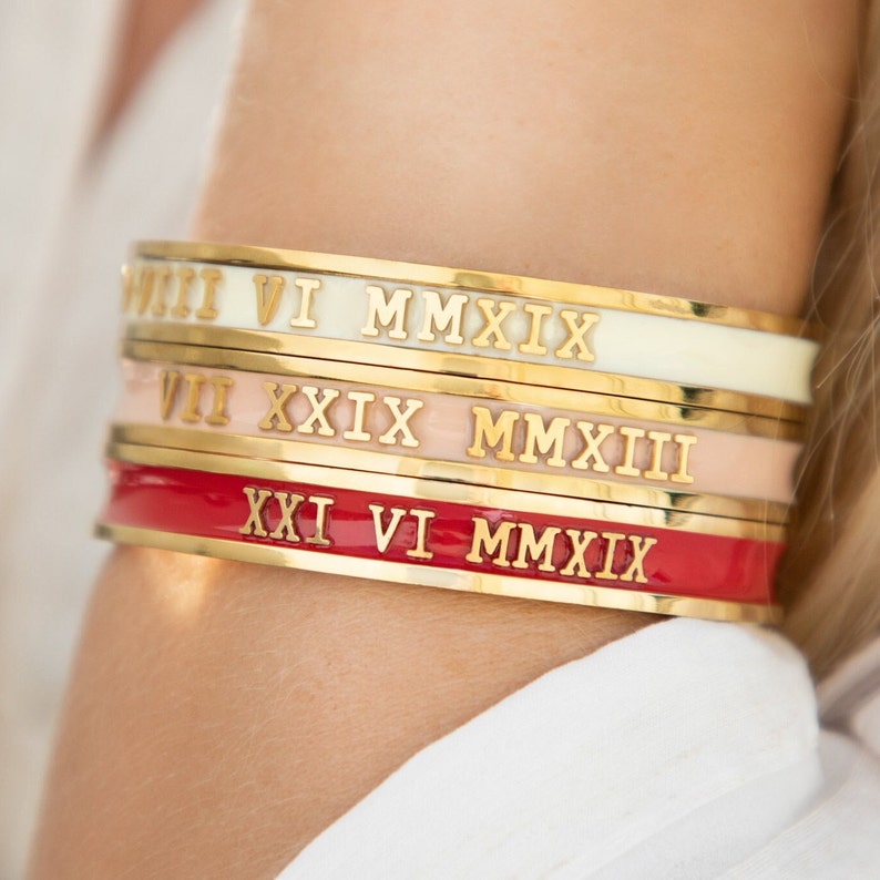 Three bangles in different colours with roman numerals