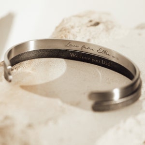 May include: Silver bracelet with an engraved message: "Love from Ellie x x We love you Dad!"