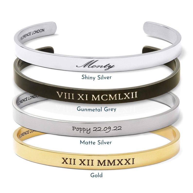 May include: Four different bracelets with various engravings. The top bracelet is silver and engraved with the word "Monty". The second bracelet is gunmetal grey and engraved with "VIII XI MCMLXII". The third bracelet is matte silver and engraved with "Poppy 22.09.22". The bottom bracelet is gold and engraved with "XII XII MMXXI".