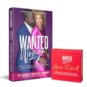 May include: A purple book titled "Wanted Woman" with a couple on the cover. The book is next to a red box with gold lettering that says "Wanted Woman Love Deck".