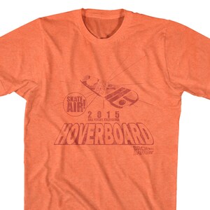 May include: Orange t-shirt with a red graphic of a hoverboard and the text "Skate Air! 2015 Hill Valley, California Hoverboard Back to the Future".