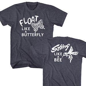 May include: Two dark blue t-shirts with white text and graphic designs. The first shirt says "Float Like a Butterfly" with a butterfly graphic. The second shirt says "Sting Like a Bee" with a bee graphic.