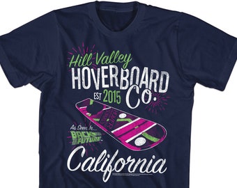 May include: A navy blue t-shirt with a white graphic of a hoverboard and the text "Hill Valley Hoverboard Co. Est 2015 California" with green and pink accents. The graphic also includes the text "As Seen In... Back to the Future."